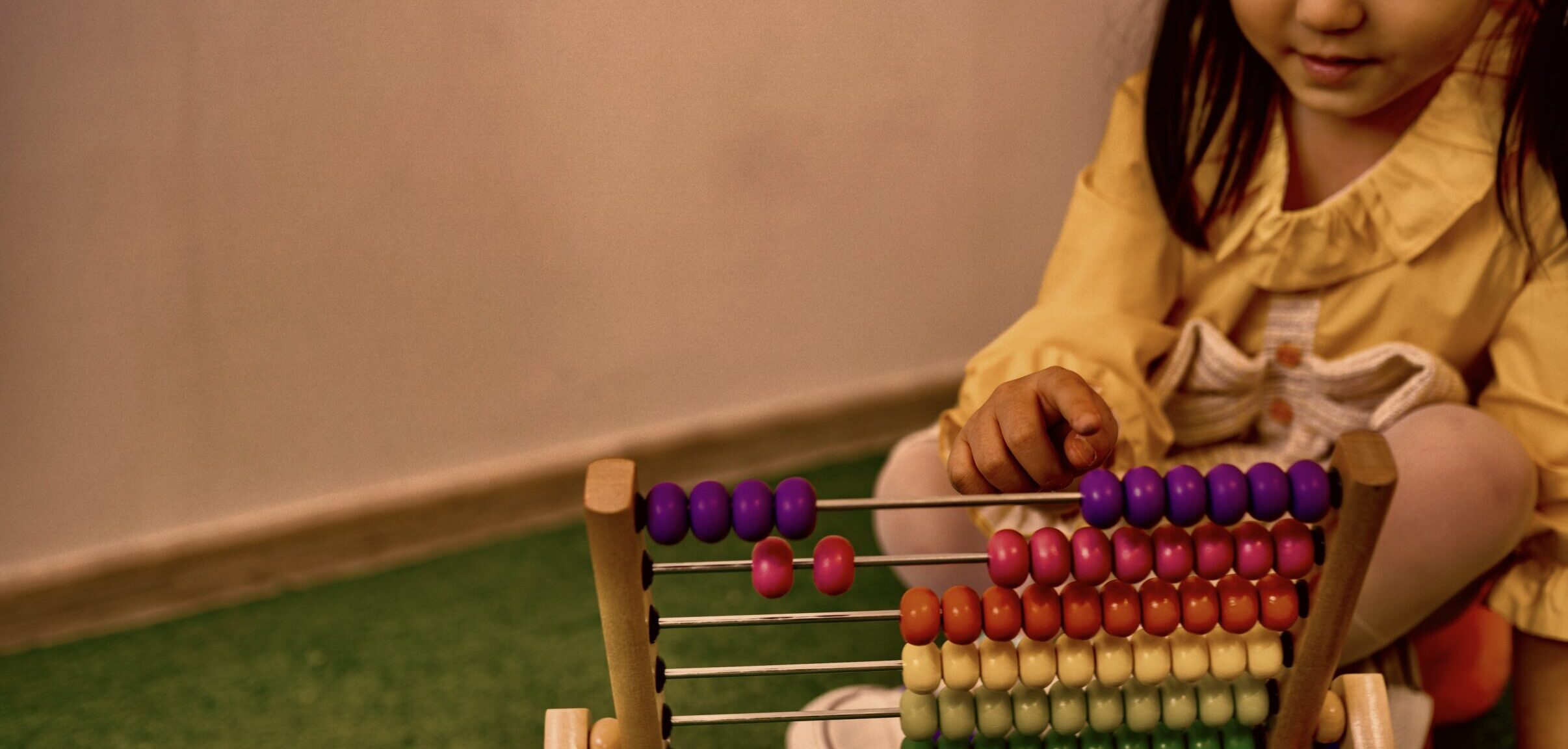 Young girl plays with abacus